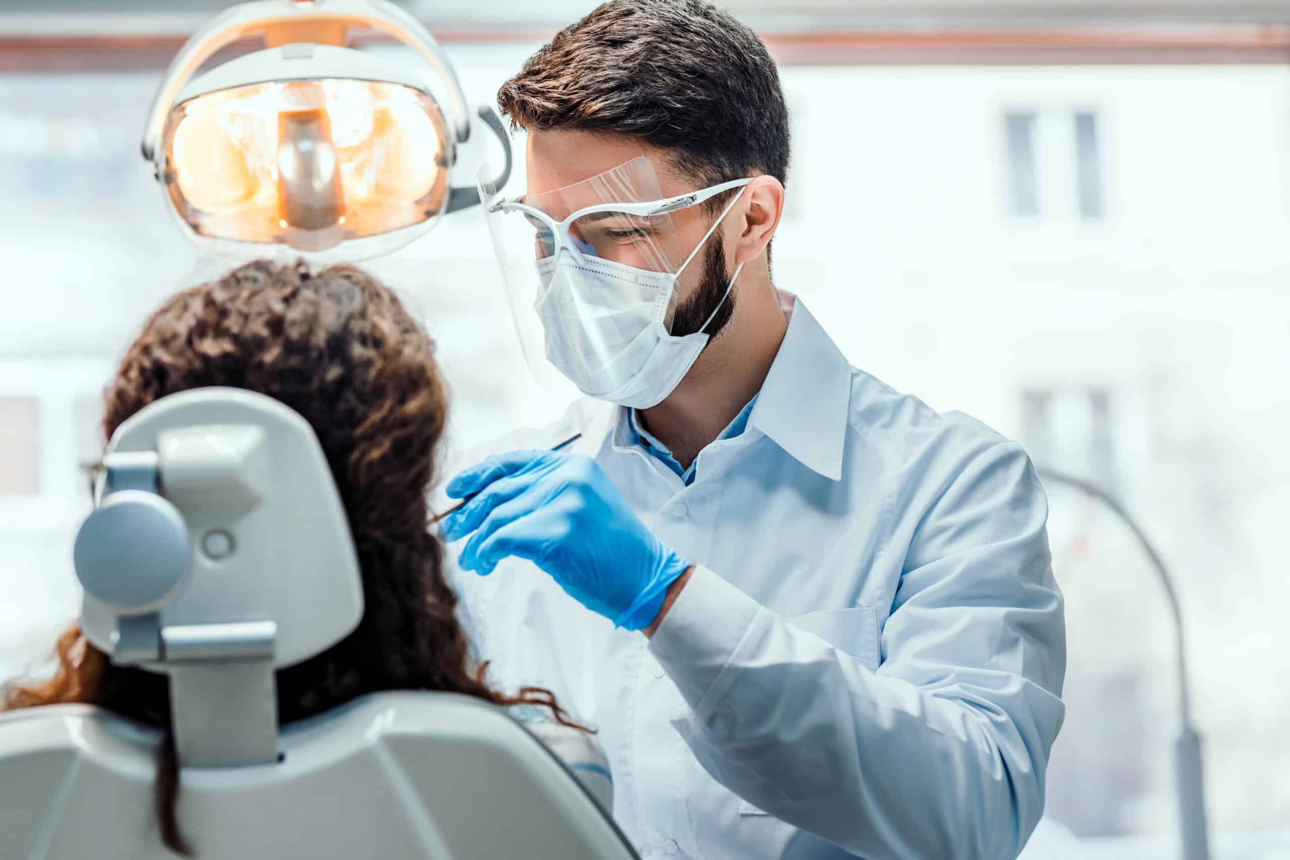 Family Dentist cleaning teeth in Epsom dental clinic